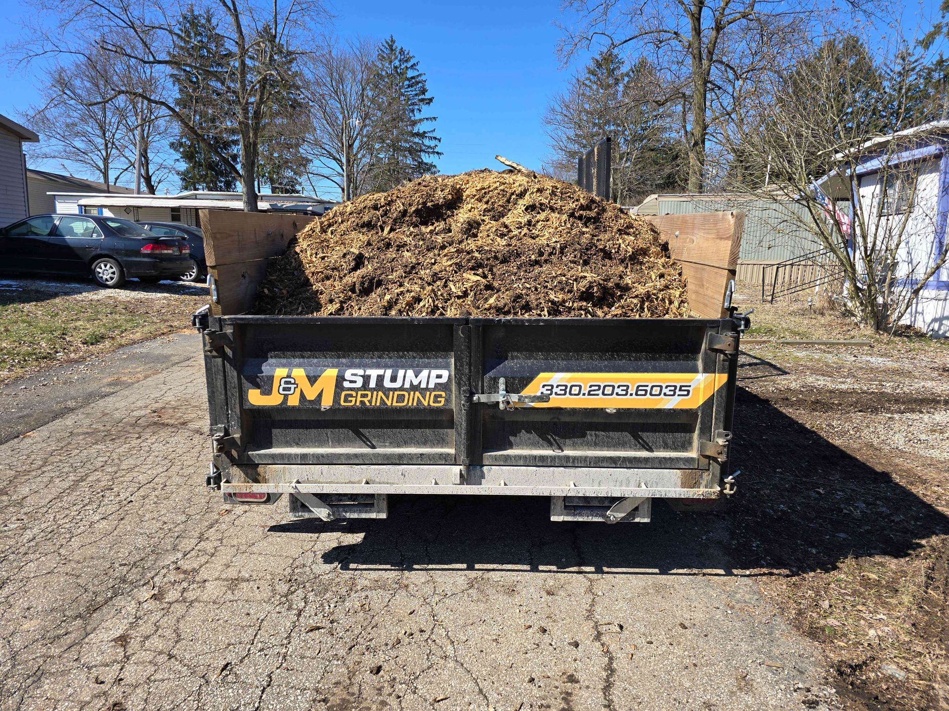 A dump truck is filled with a large pile of dirt.
