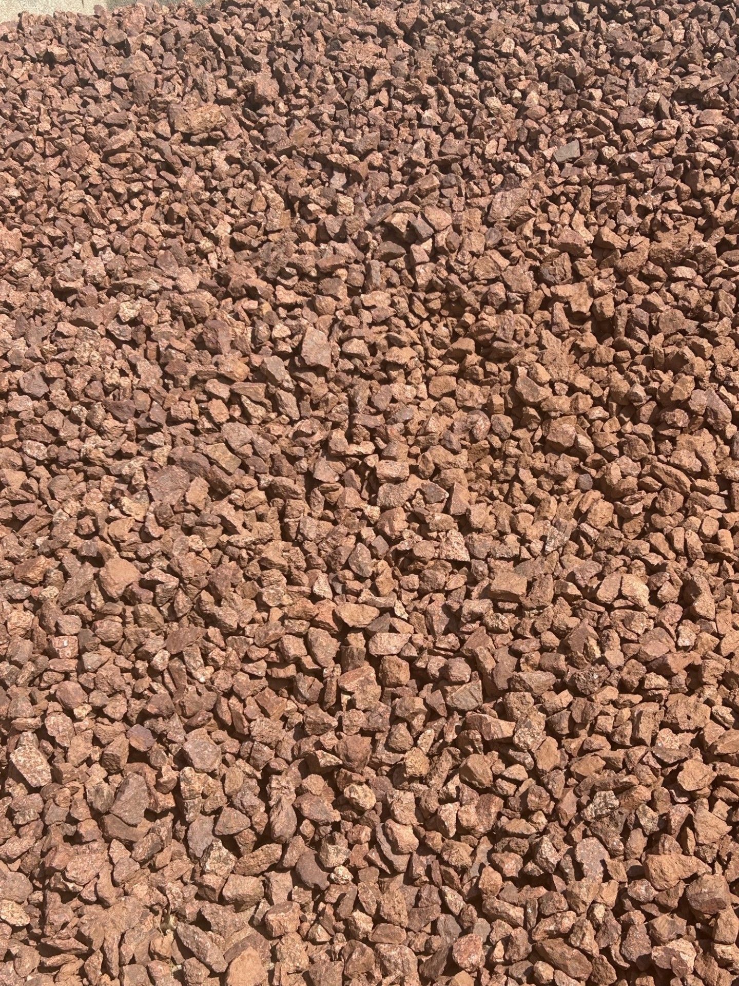 Reddish-brown, small gravel, likely used for landscaping or ground cover.