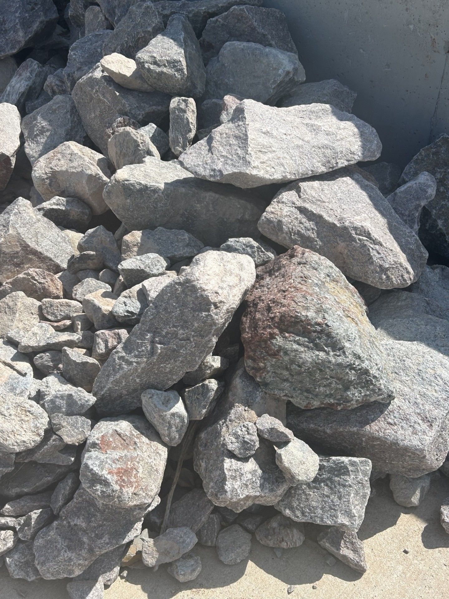 Pile of gray and white rocks, possibly granite.