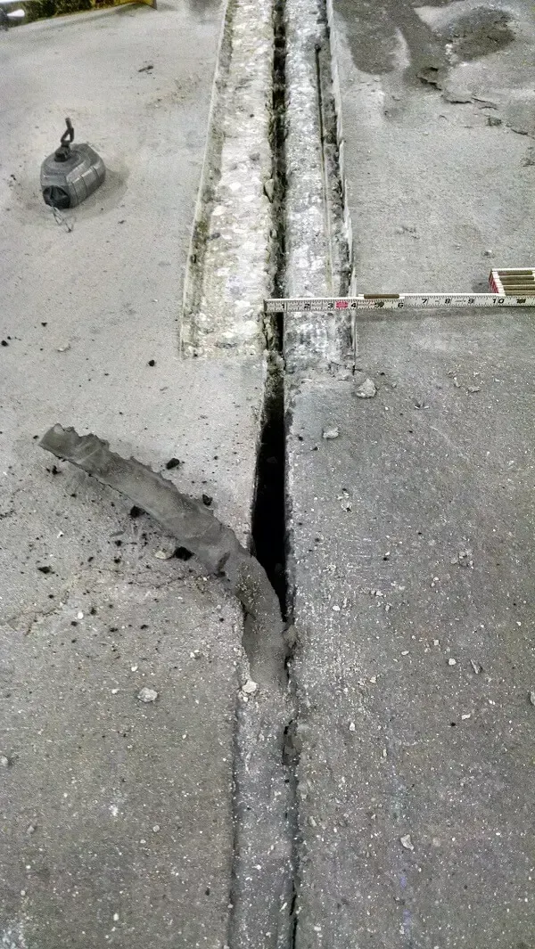 Concrete floor with a deep, open joint or gap.