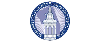 Logo of Burlington County Bar Association, featuring a tower and text within a blue circle.