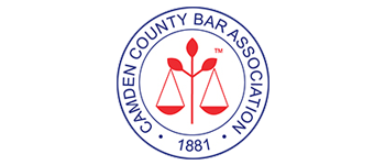 Camden County Bar Association logo: red scales of justice in a blue circle with text and the year 1881.