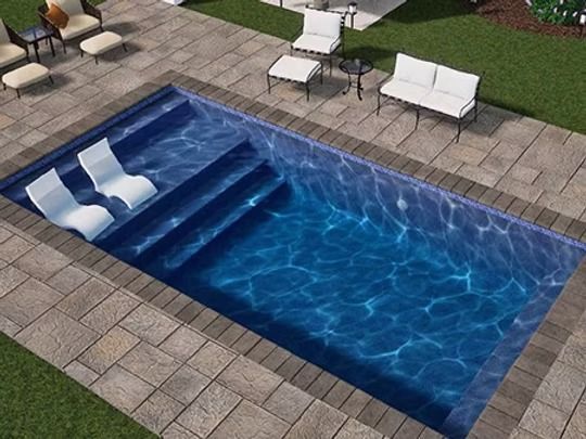 Rectangular backyard pool with steps, lounge chairs, and patio furniture.