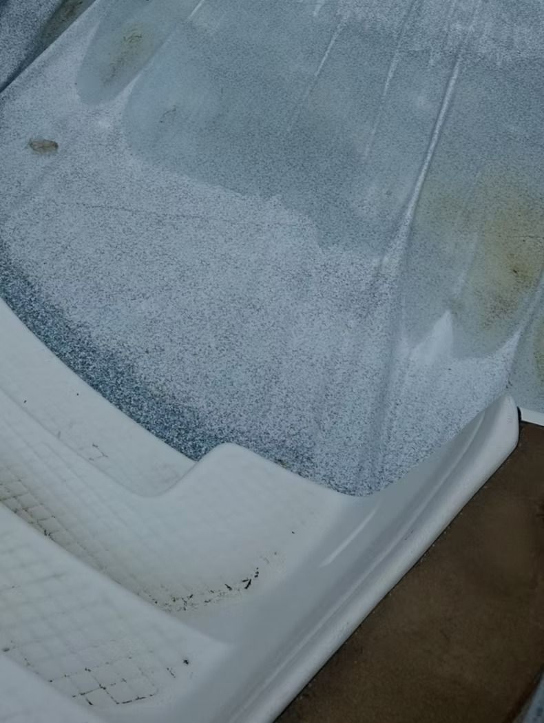 Fiberglass surface showing numerous fine cracks. White steps and surrounding plastic material.