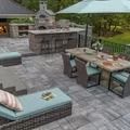 Outdoor patio with dining and seating areas, and a brick pizza oven.