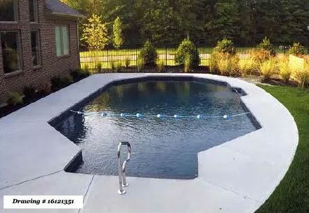 A rectangular backyard swimming pool with a shallow end step-out, surrounded by a light-colored concrete deck near a house.