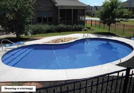 A kidney-shaped swimming pool with blue water, light grey concrete decking, and a stone planter, viewed from a patio fence.
