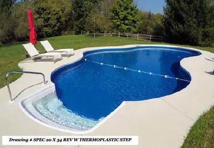 An outdoor kidney-shaped swimming pool with a white thermoplastic entry step, a safety rope, and two lounge chairs.