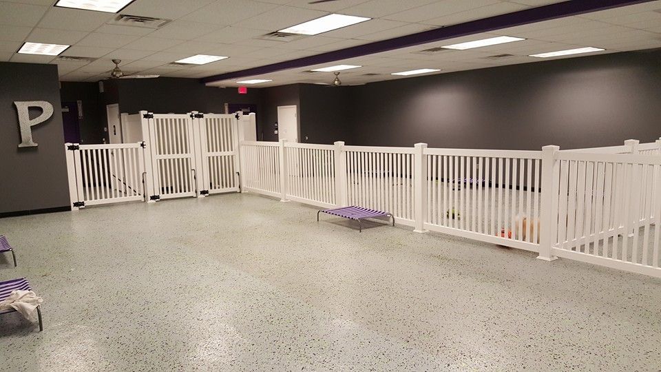 An empty room with a white fence and a sign that says p.