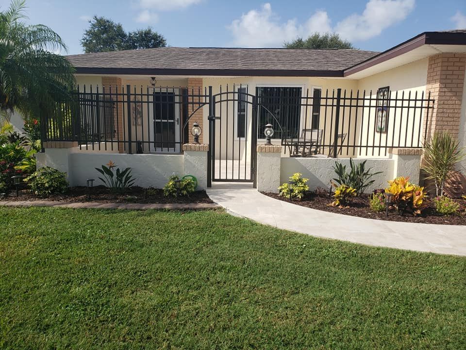 A house with a fence around it and a walkway leading to it