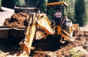 A worker operating the excavating machine