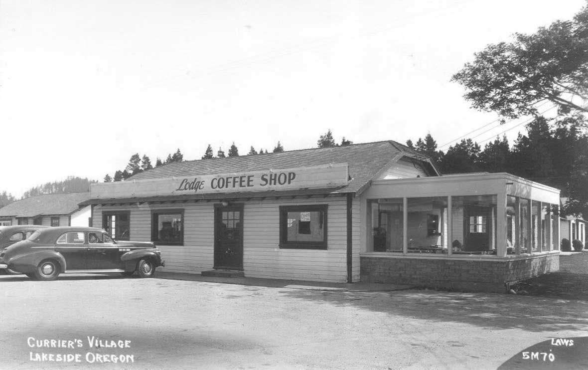 a coffee shop with cars parked outside