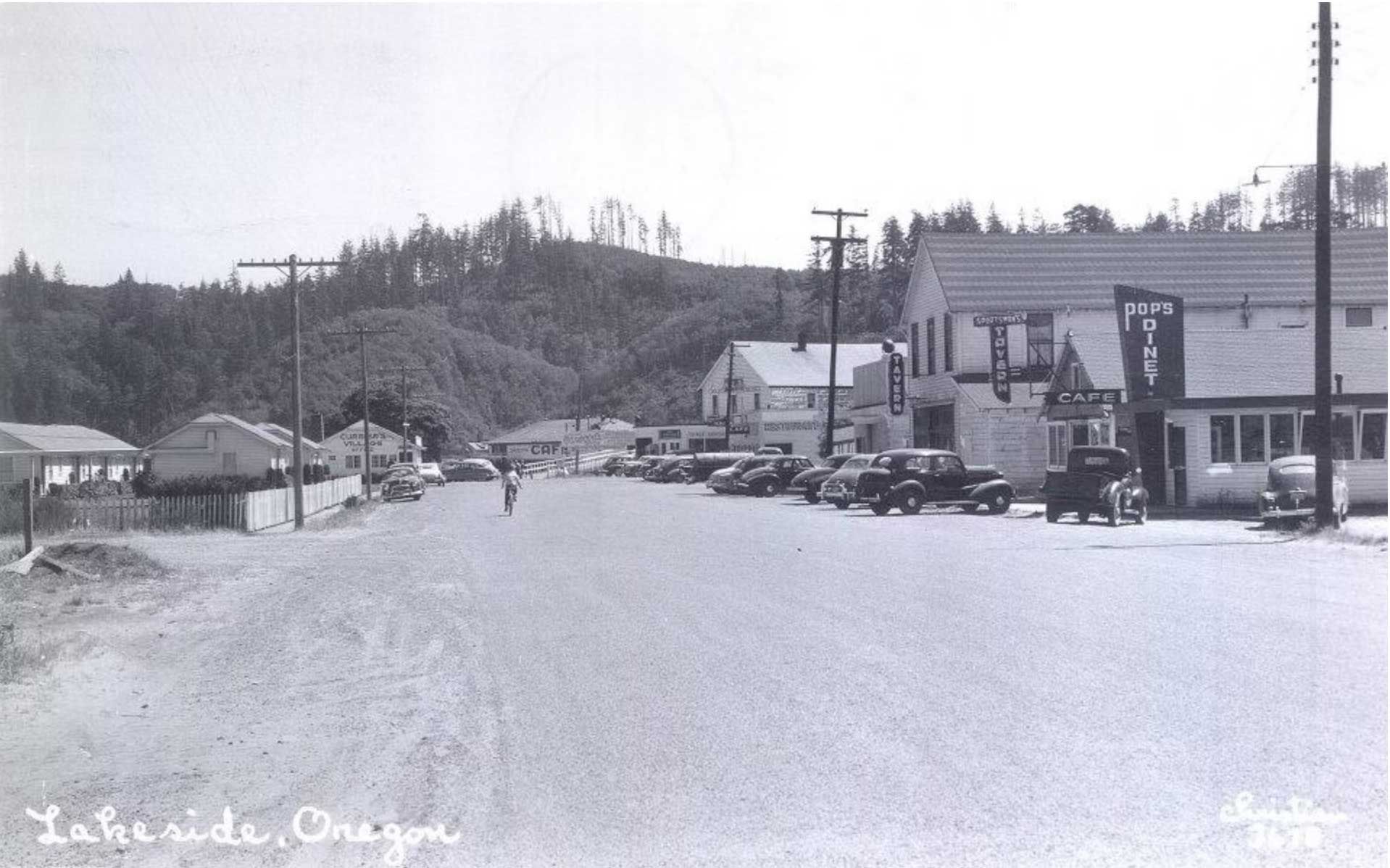 street view of Lakeside, Oregon, with cars parked along the road and buildings lining the street
