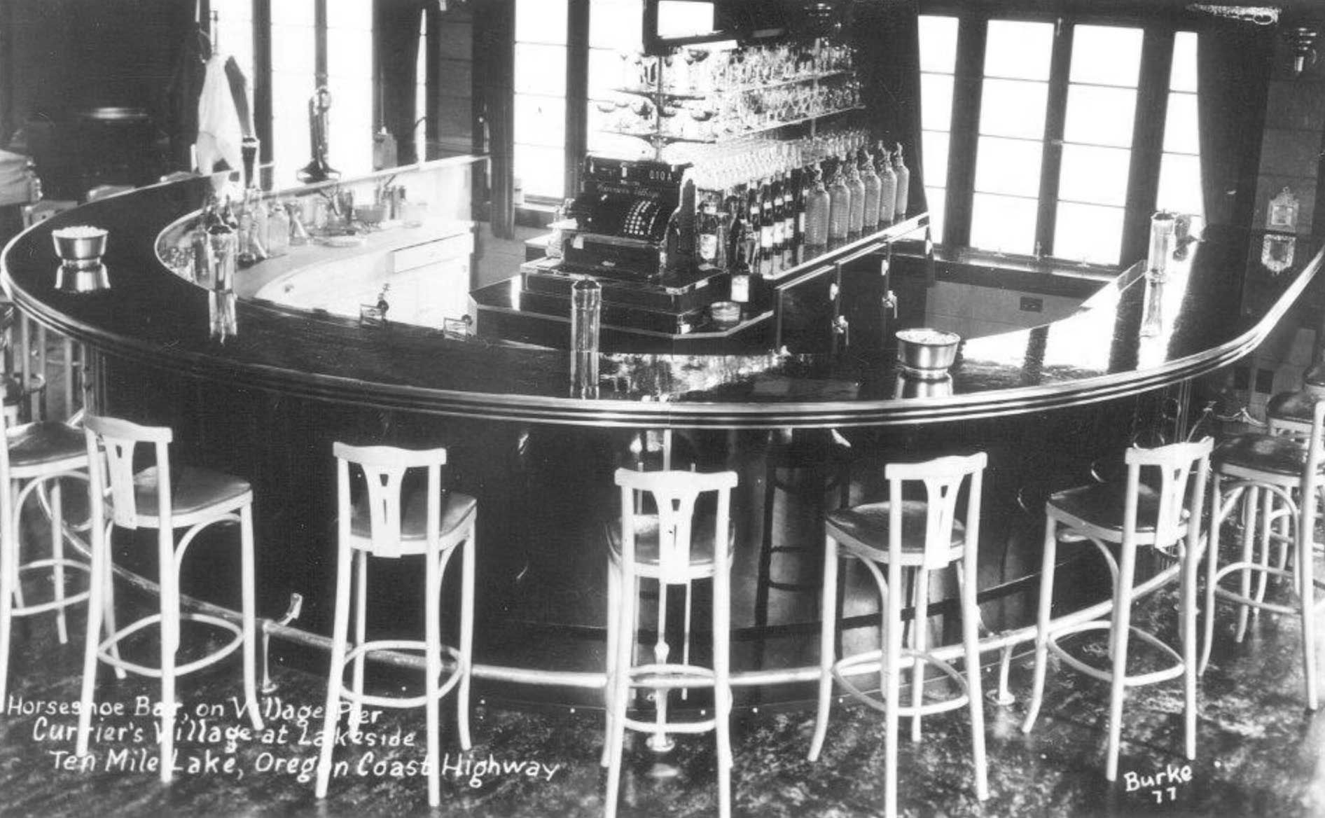 circular bar with high stools and bottles behind