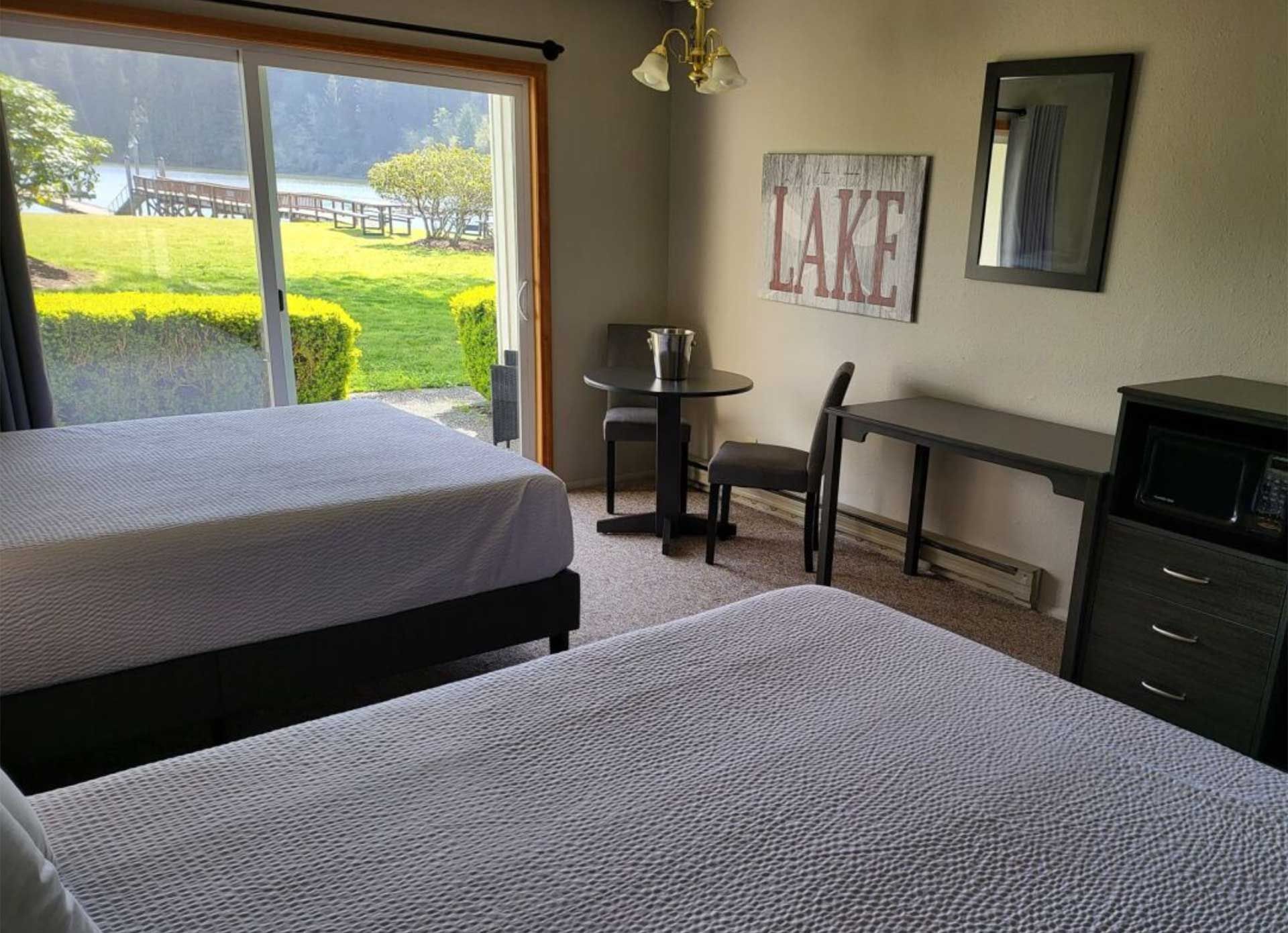 hotel room with two beds and a lake view