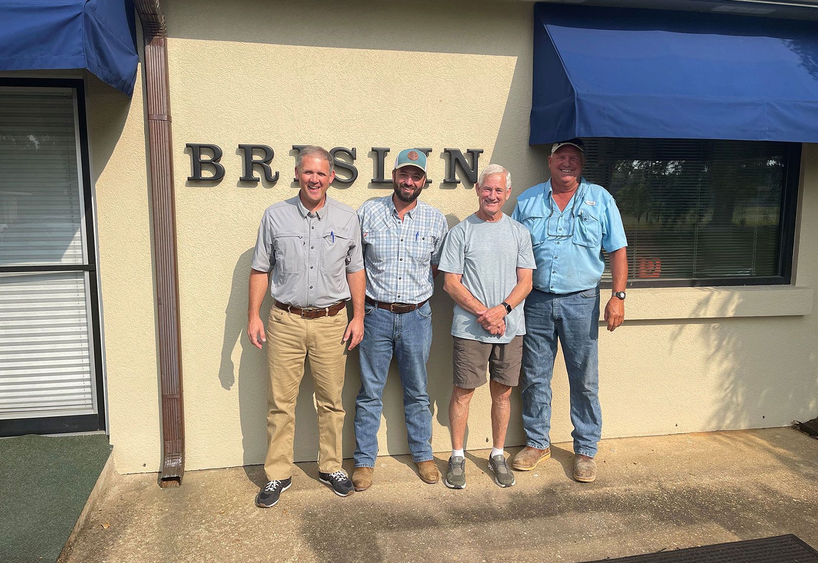 Office men in front of Brislin