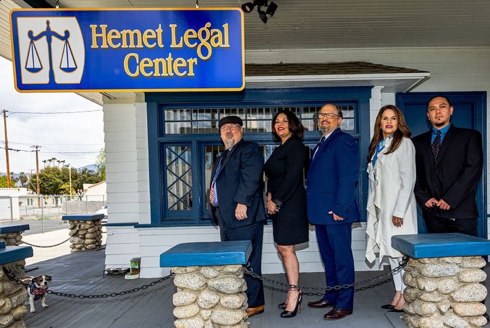 A group of people are posing for a picture in front of a building.