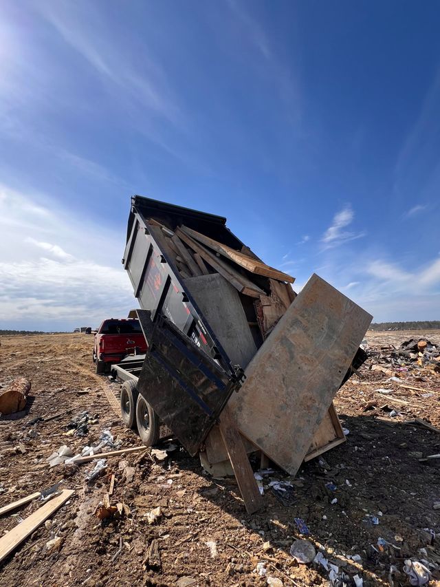 Damaged small structure leaning in a rocky desert under a blue sky