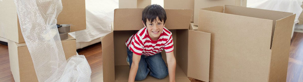 Child in moving boxes