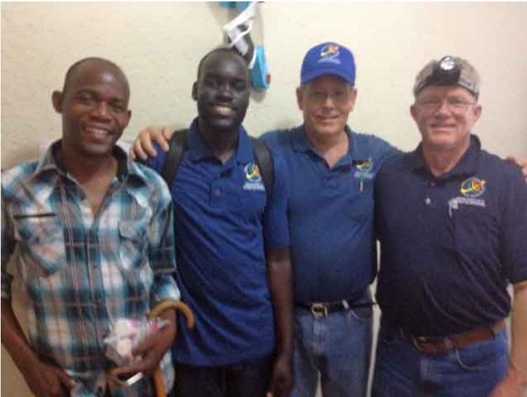 A group of men posing for a picture with one wearing a blue shirt that says ucsd