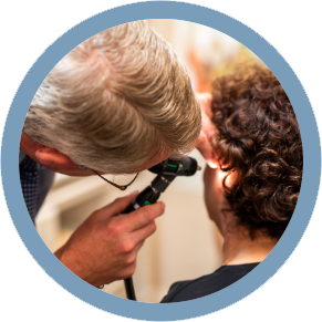 A doctor examines a patient 's ear with a stethoscope