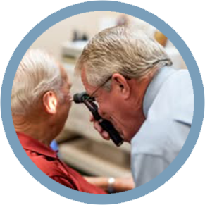 A man is examining another man 's ear