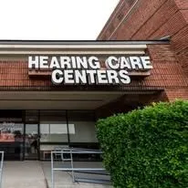 A hearing care center is located in a brick building.