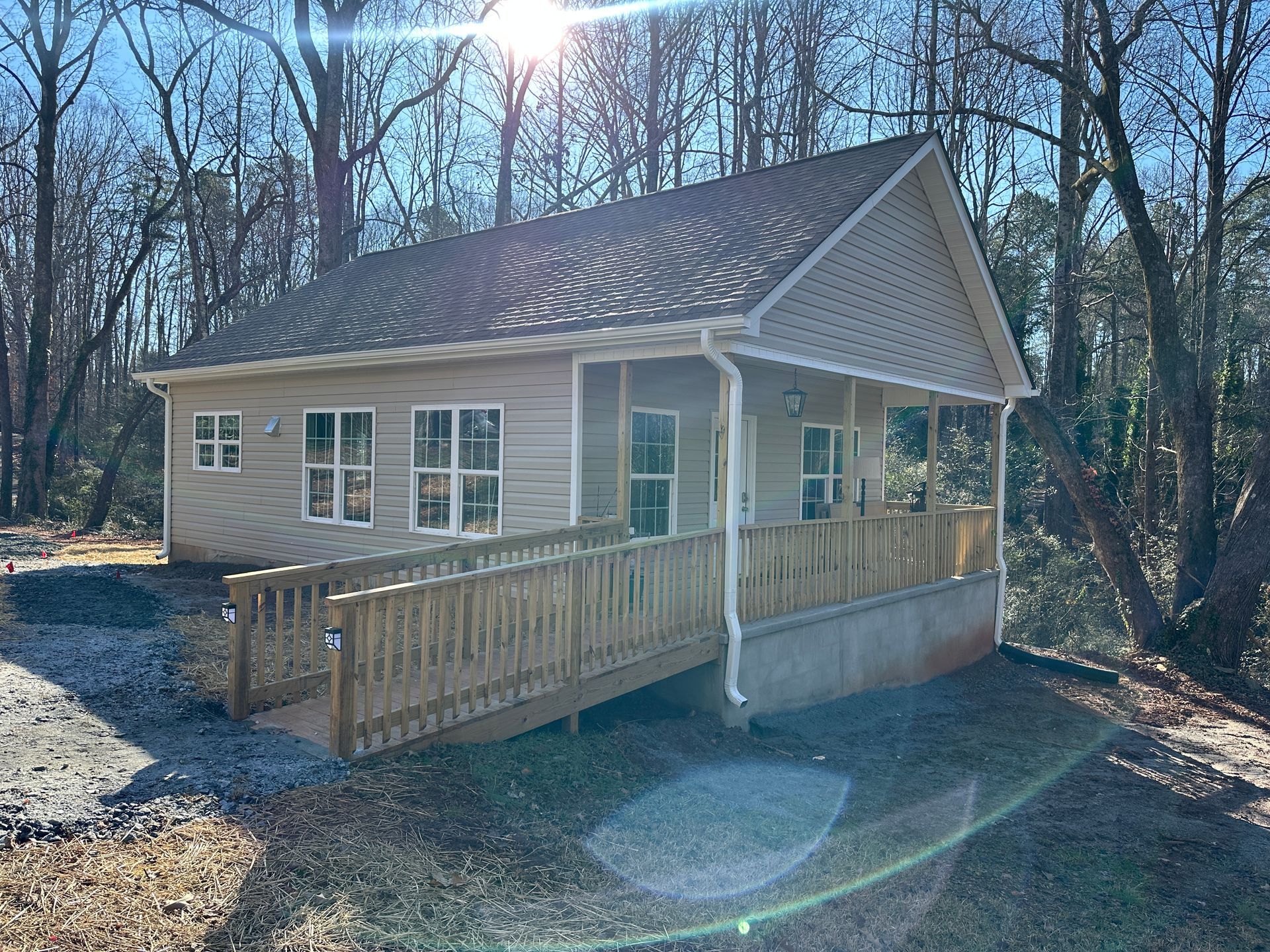 Outdoor shot of the side of a tan house with a wheelchair ramp