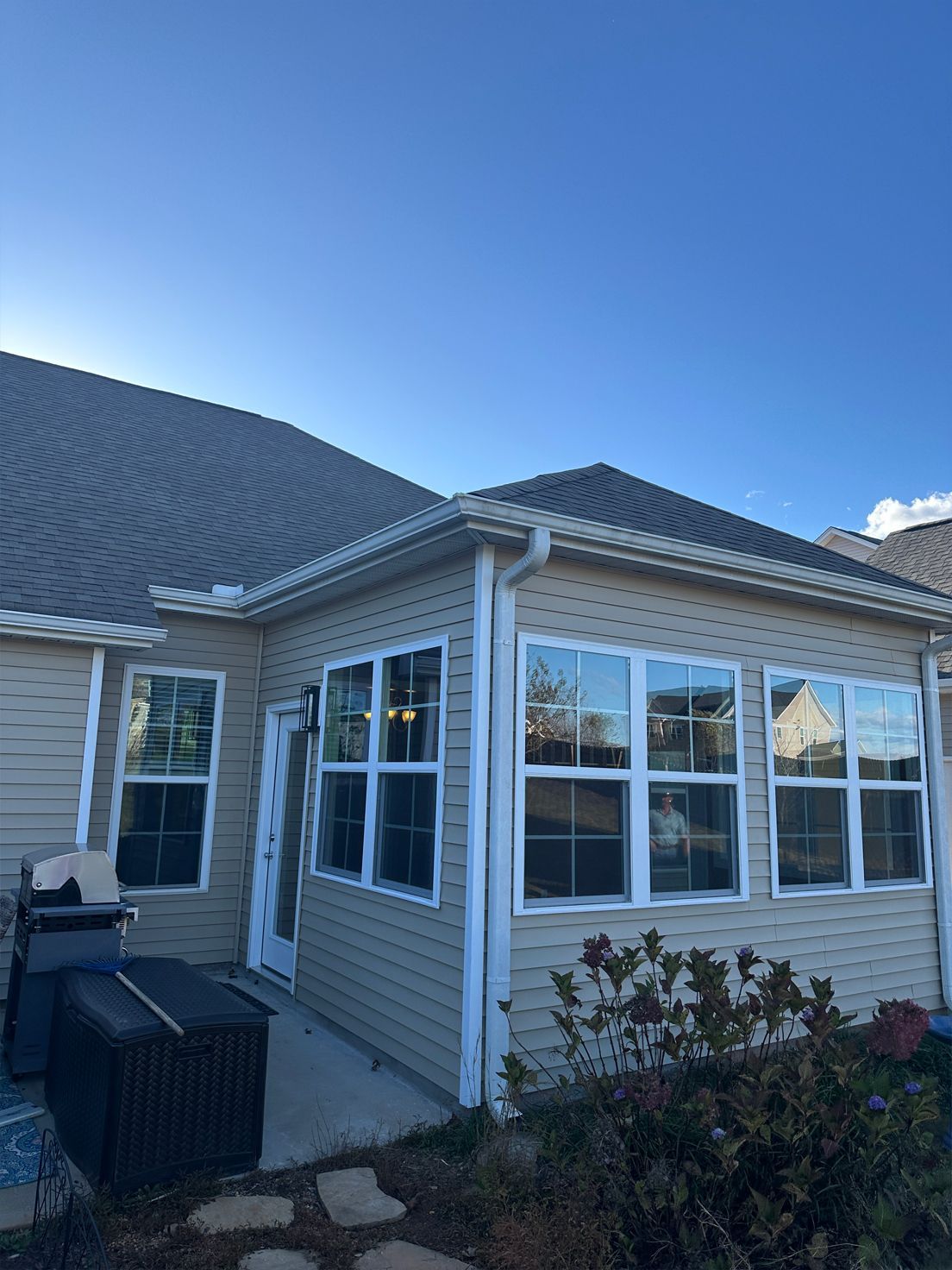 A house with a lot of windows and a blue sky in the background.