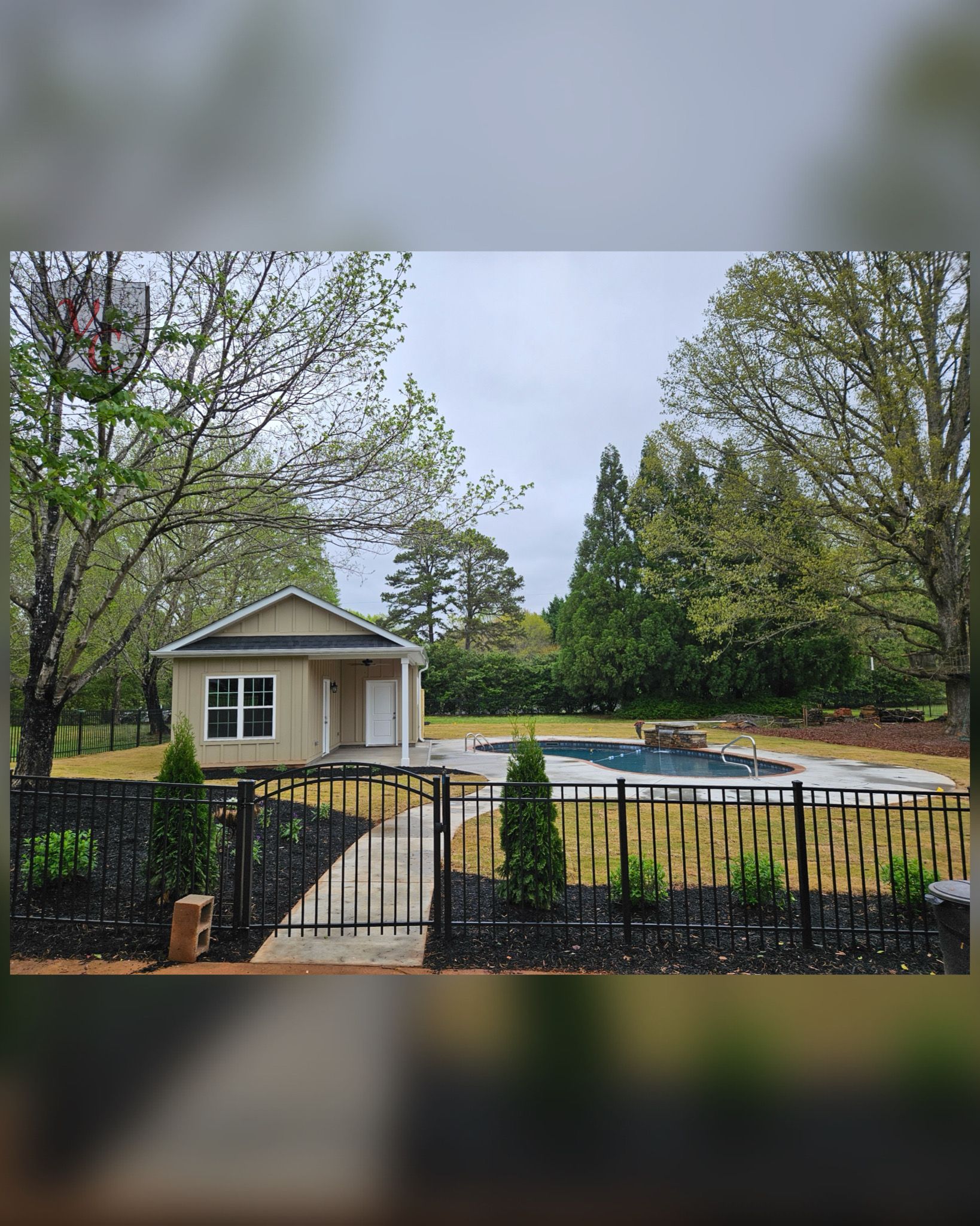 A small house with a pool in the backyard