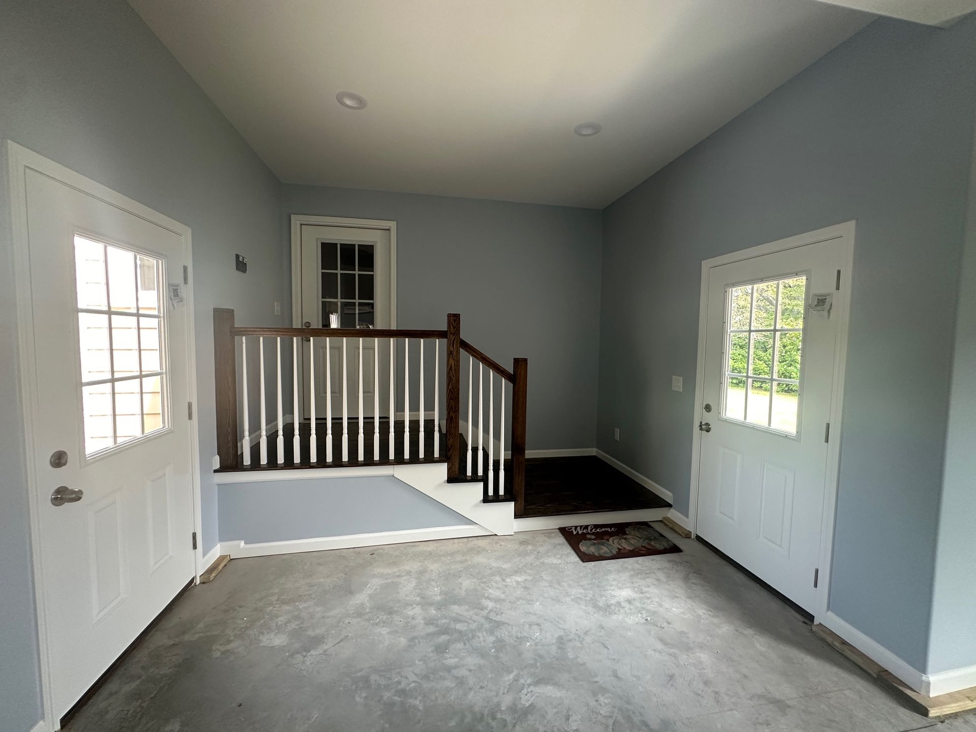 An empty room with a staircase leading up to the second floor.