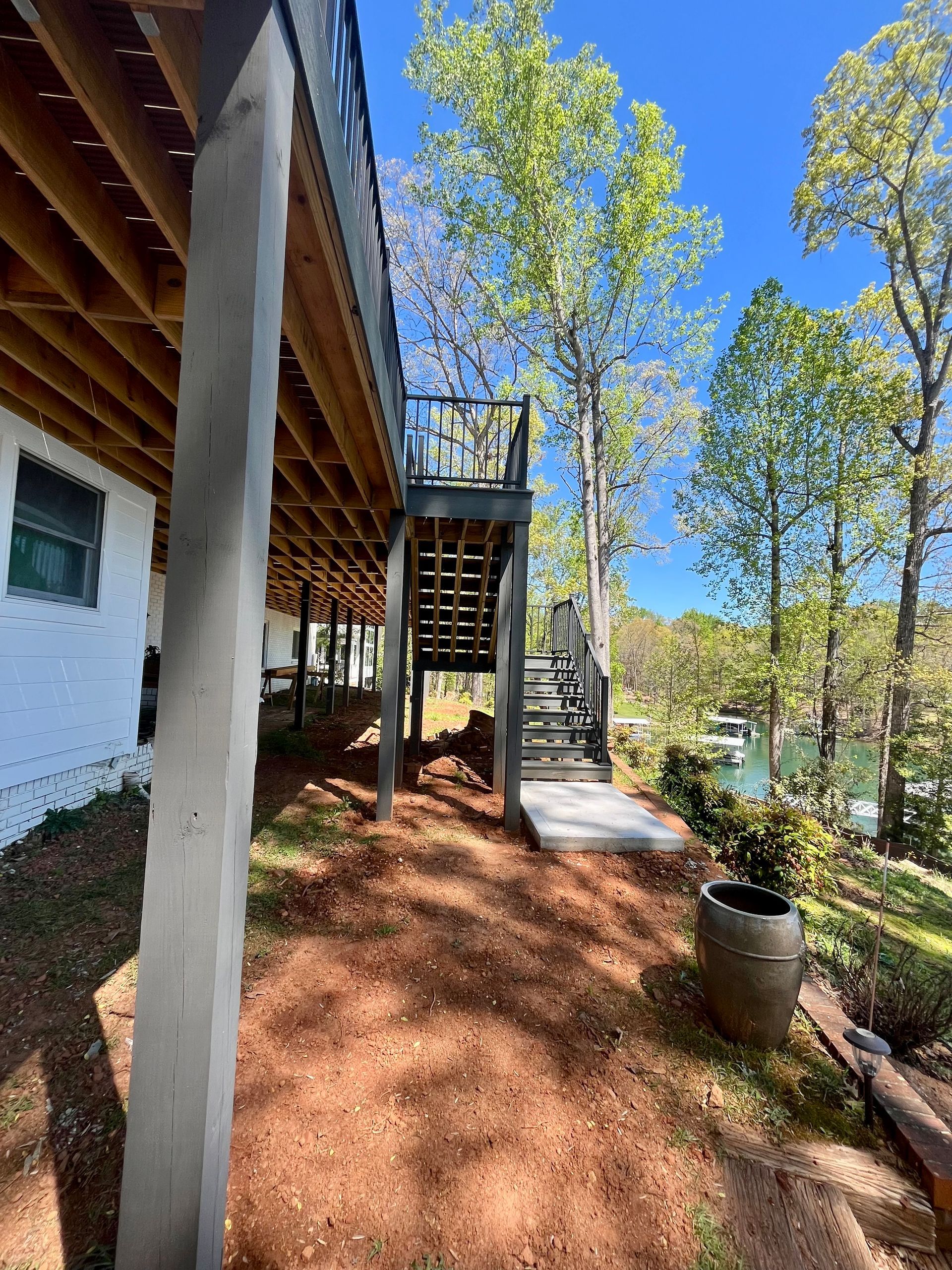 A house with a large deck and stairs leading up to it.