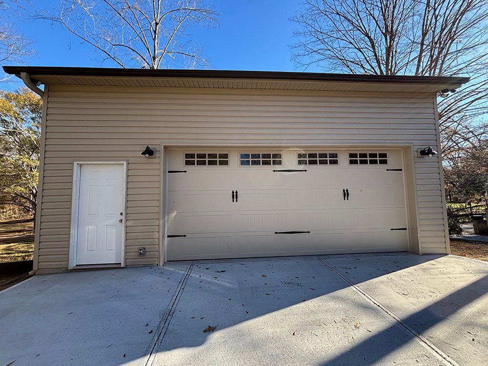 A garage with two garage doors and a white door