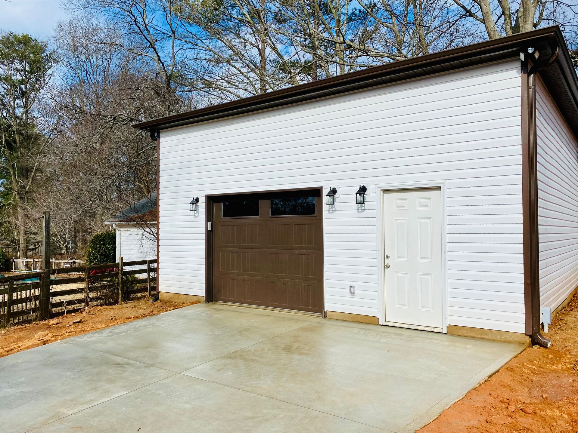 garage with chocolate-colored garage door with a driveway