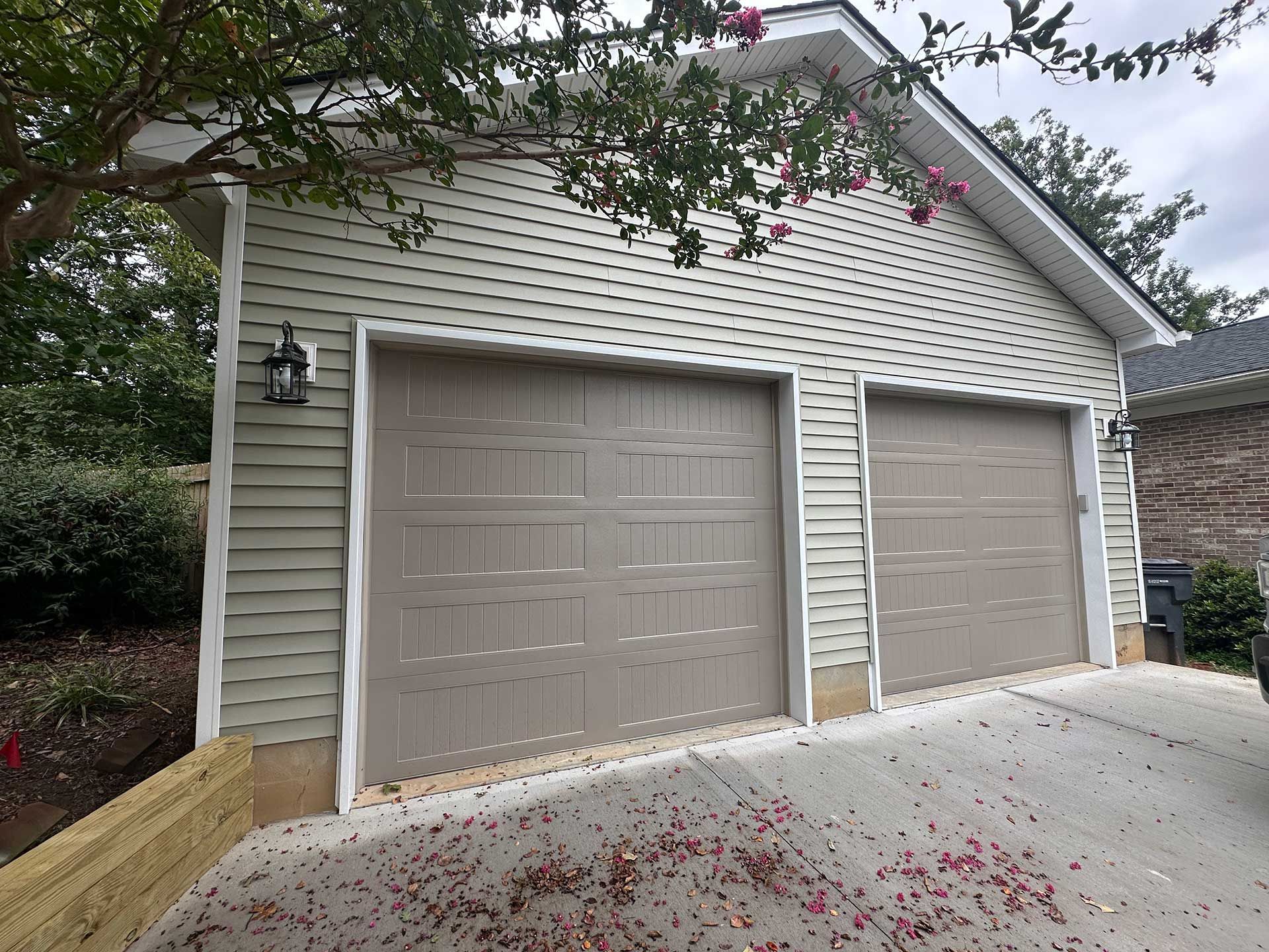 A two-door garage with lamps on the sides
