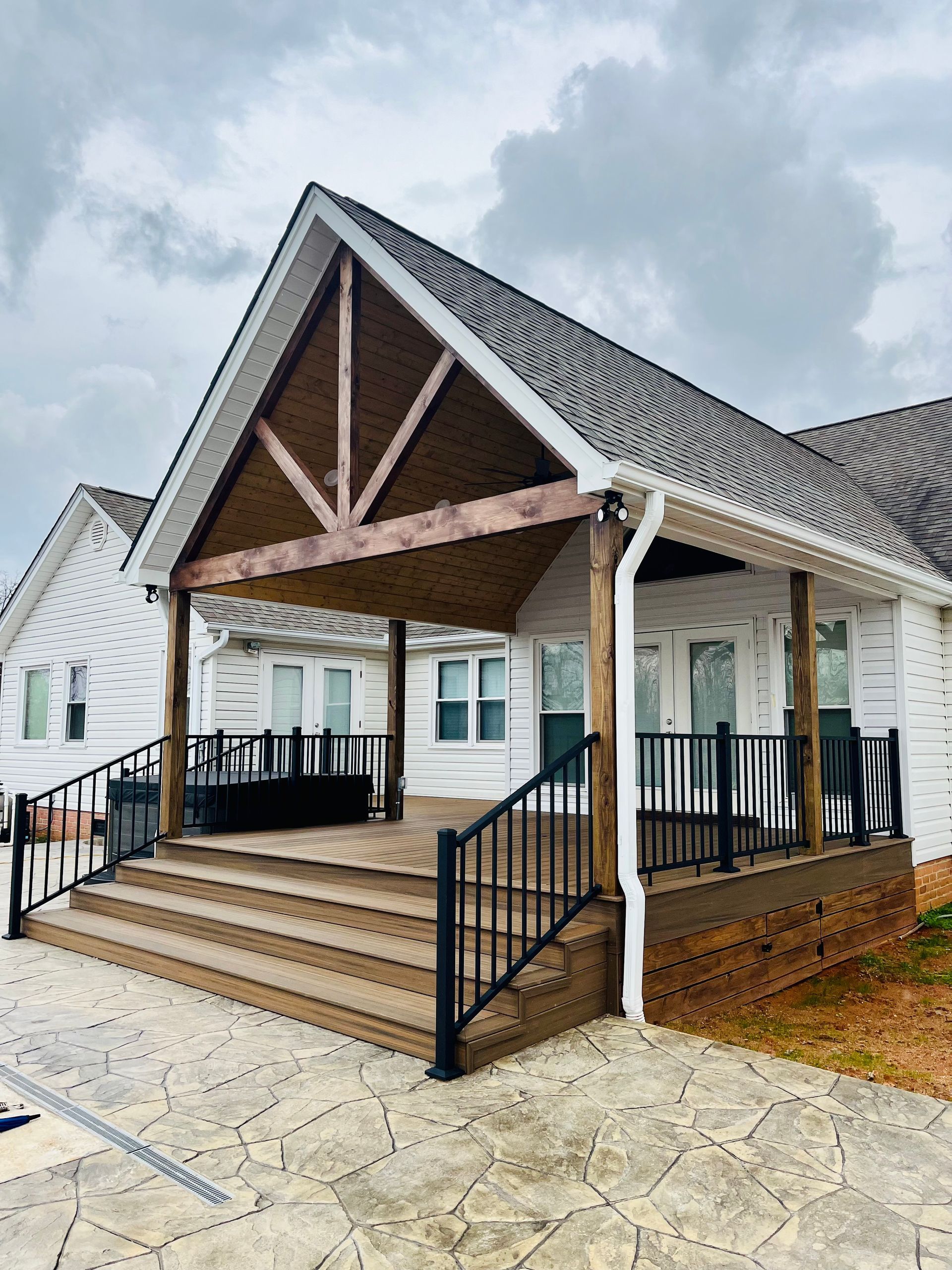 A white house with a large porch and stairs