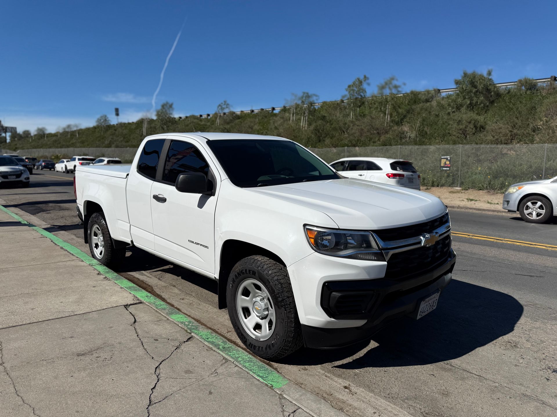 White pickup truck parked in a lot on a sunny day