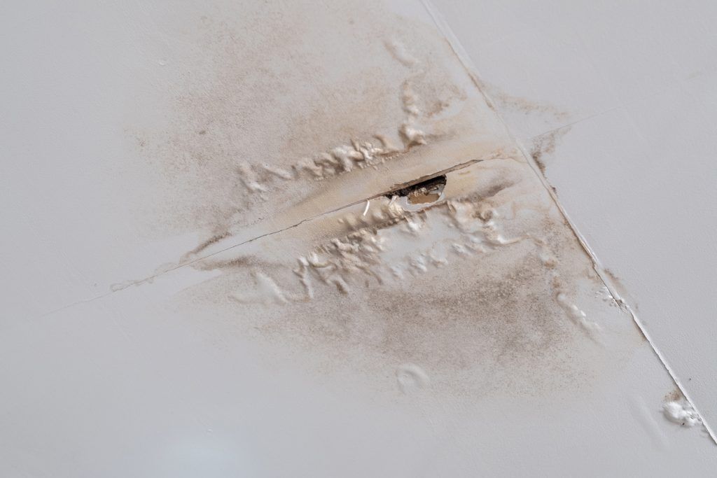 A close up of a piece of paper with a hole in it.