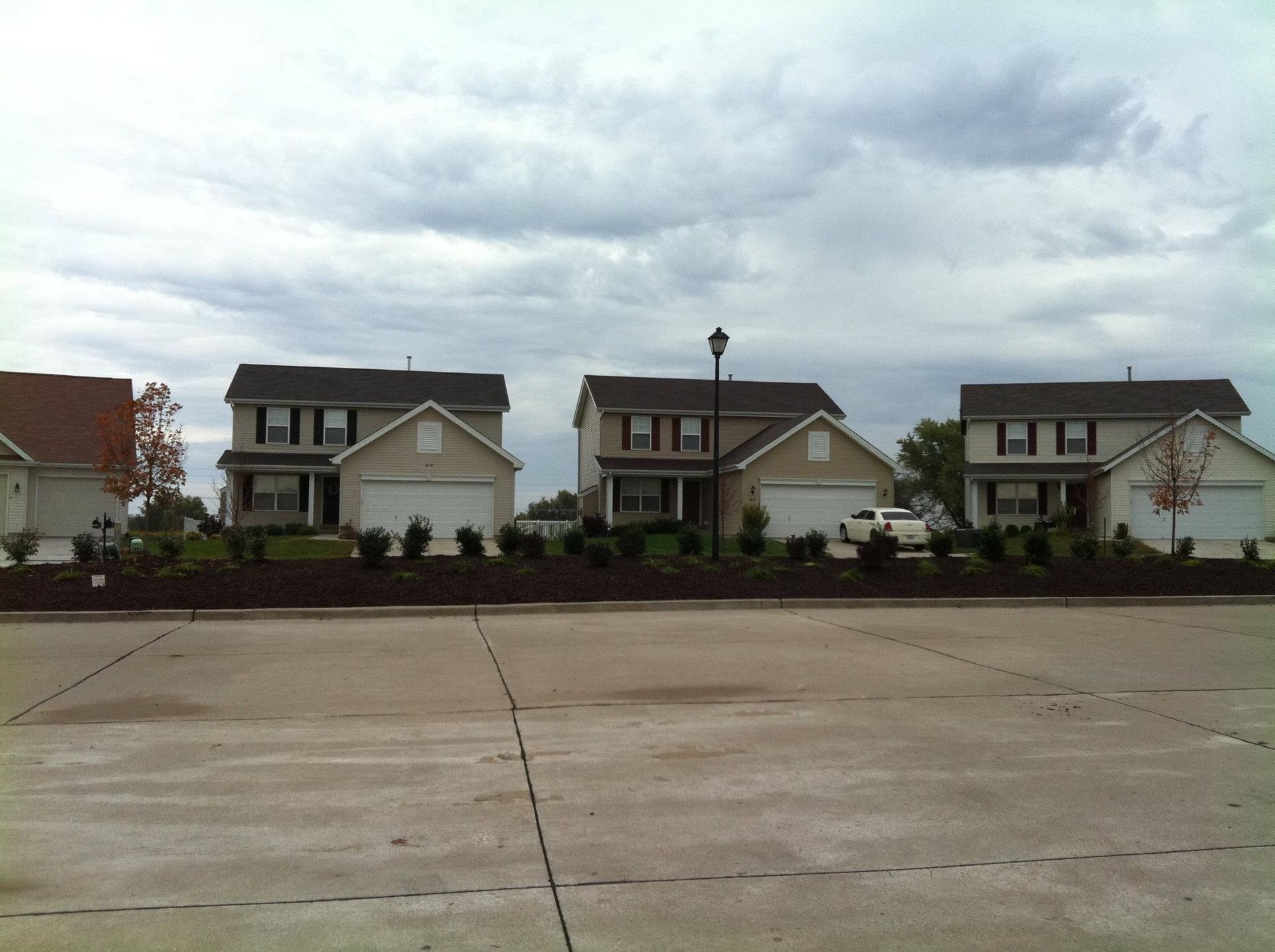 A row of houses are lined up on a cloudy day