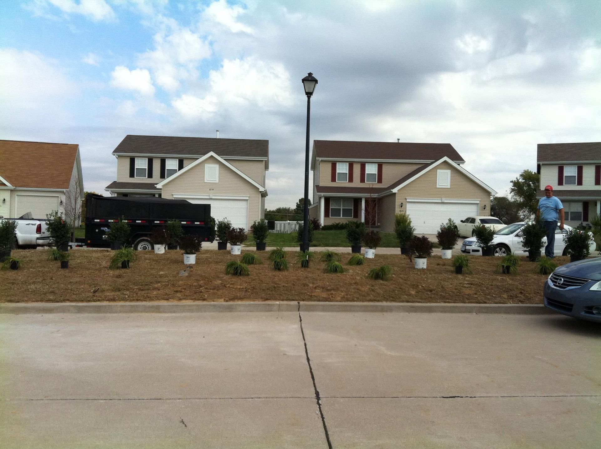 A car is parked in front of a row of houses
