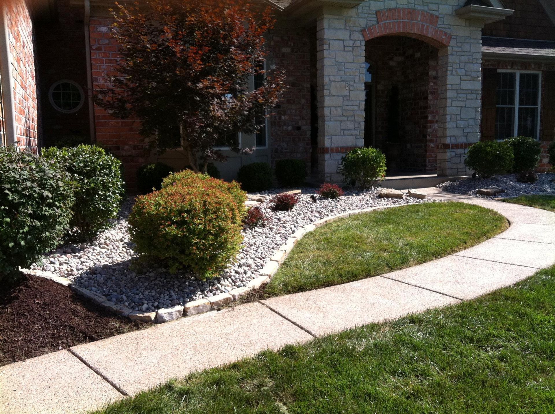 A brick house with a walkway leading to it