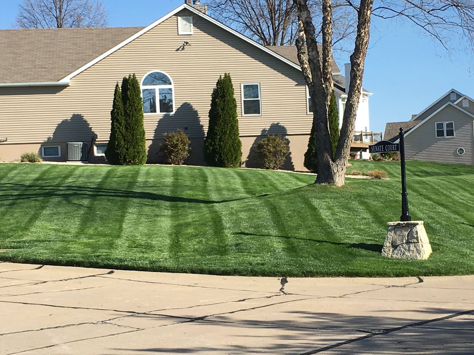 A house with a lush green lawn in front of it