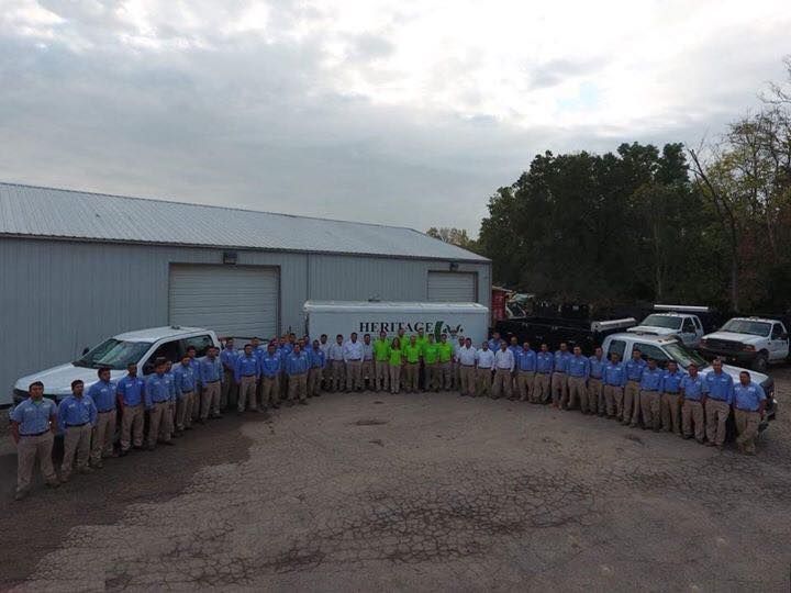 A large group of people are posing for a picture in front of a building