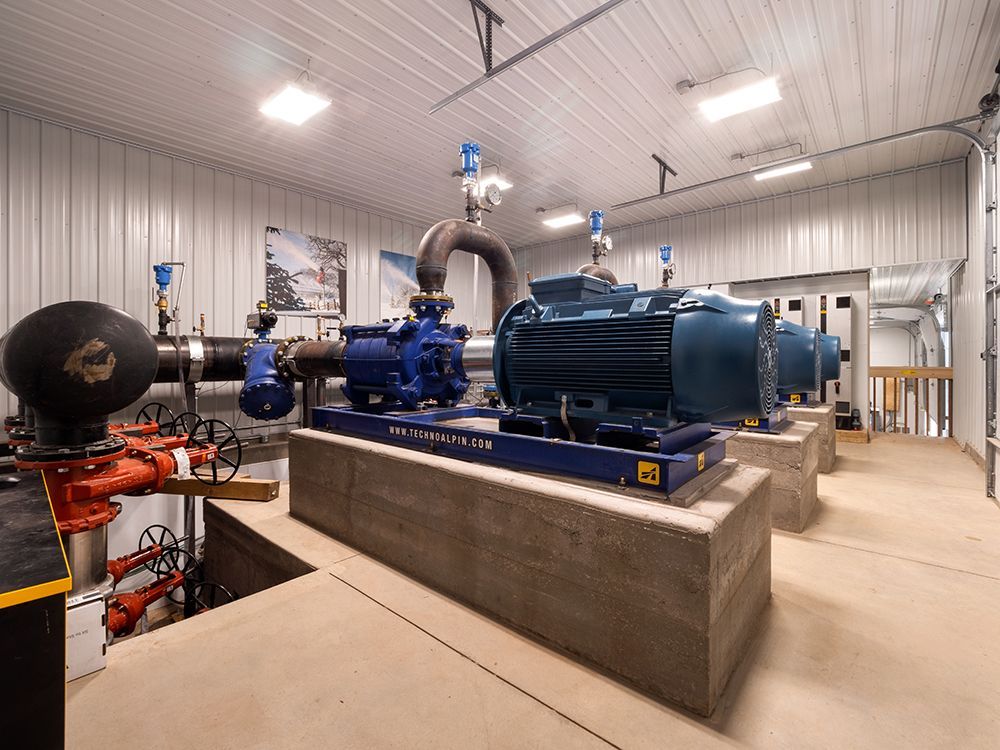 A room with a lot of pumps and pipes in it.