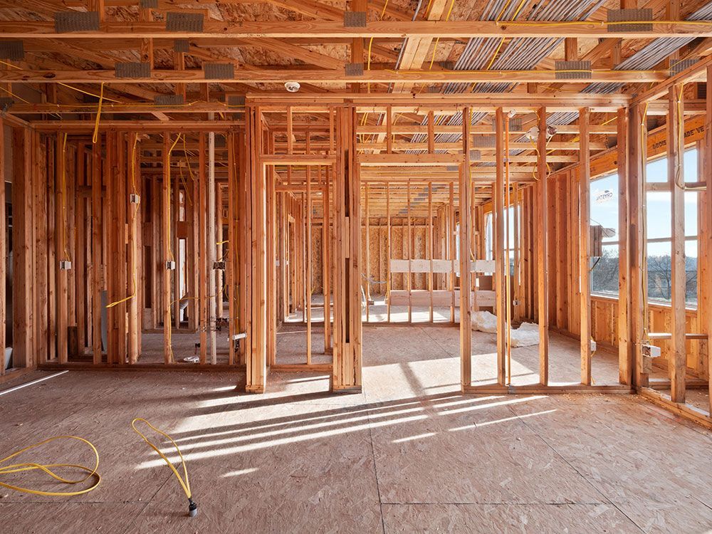 The inside of a house under construction with wooden beams.