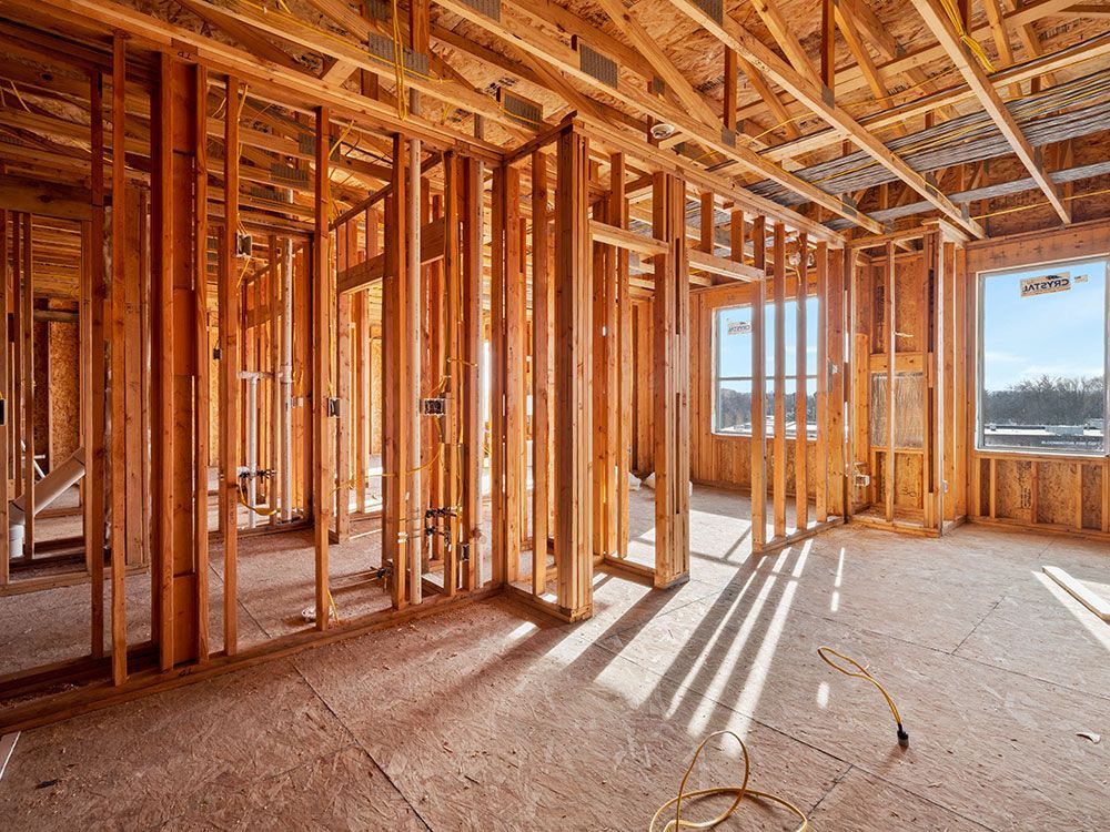 The inside of a house under construction with wooden beams.