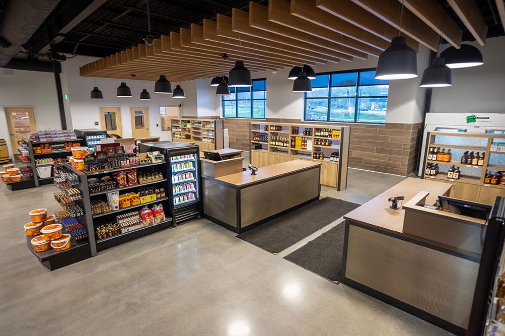 A grocery store with a lot of shelves and a cash register.