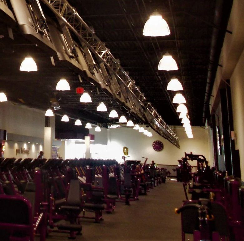A gym with a large clock on the wall