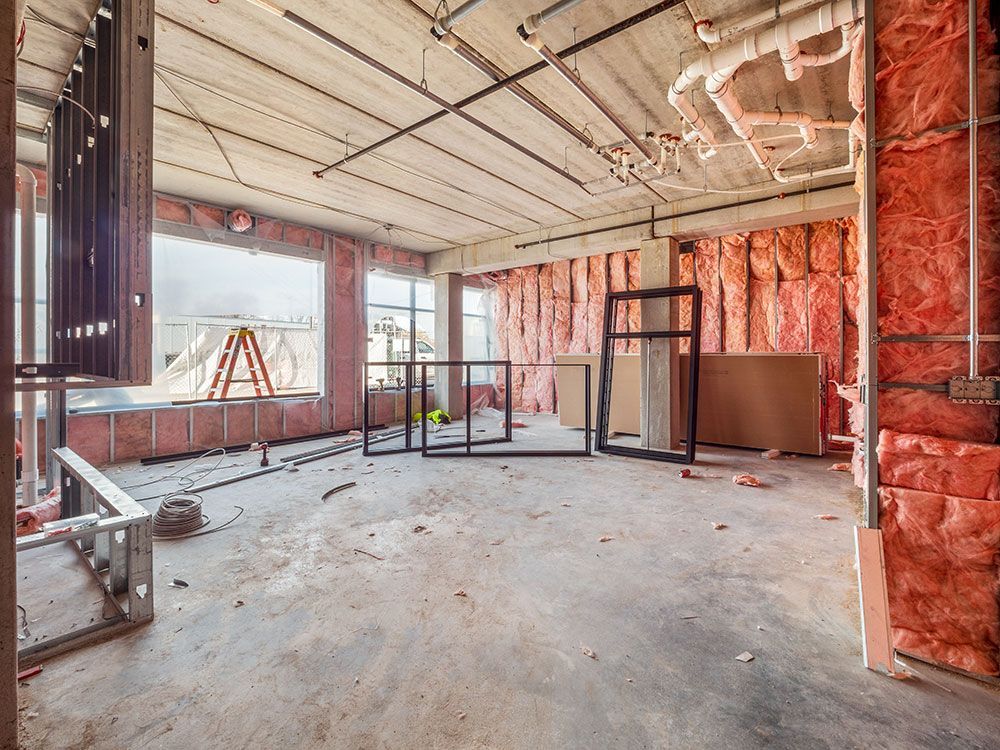 An empty room in a building under construction with insulation on the walls.