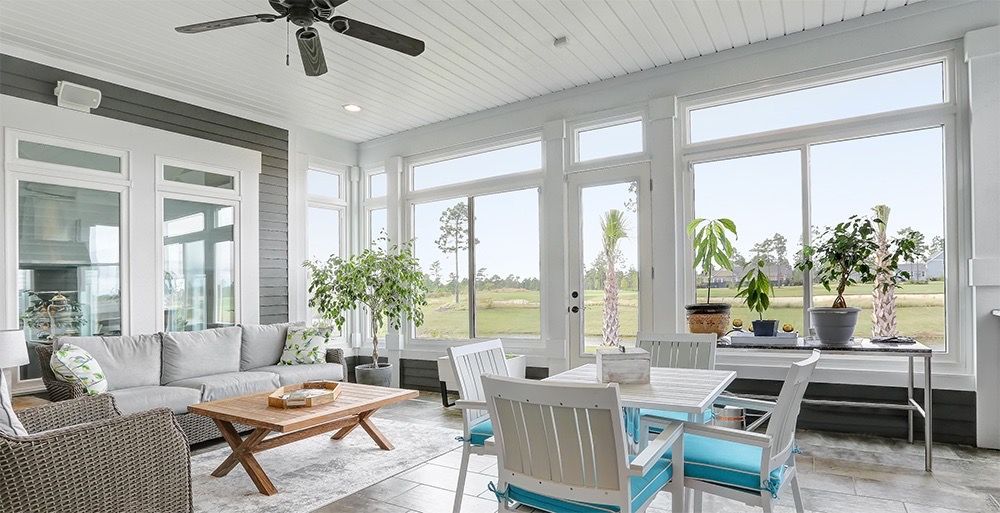 A living room filled with furniture and a ceiling fan.